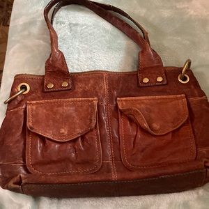Rugged well loved orangish brown genuine Fossil leather hand bag / purse